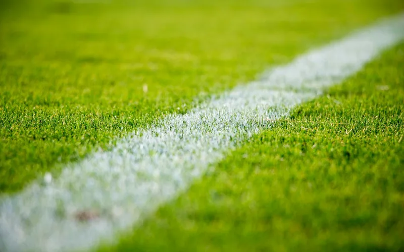 Football resting on stadium turf where same game multi legs are combined for real money stakes