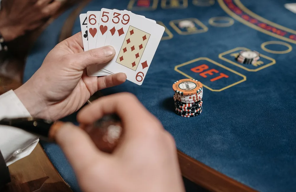 Playing cards and chips dealt on dark felt for blackjack and baccarat card games