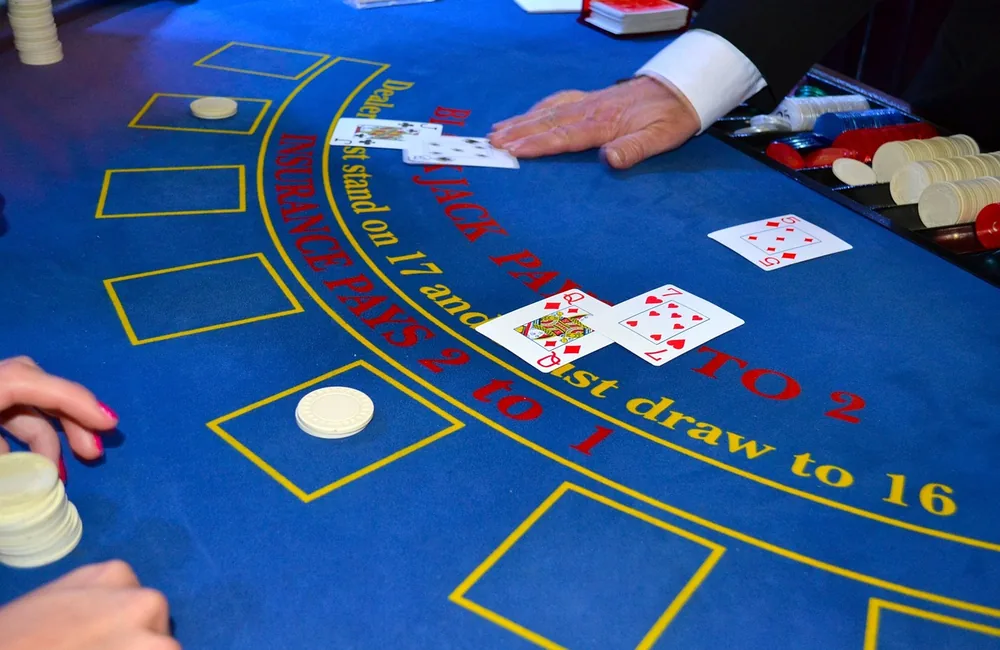 Dealer’s hands at a live dealer table games studio streamed to online casino players
