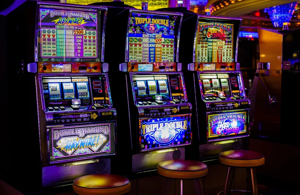 Spinning slot machine reels and paylines on an online pokies screen in a gaming venue