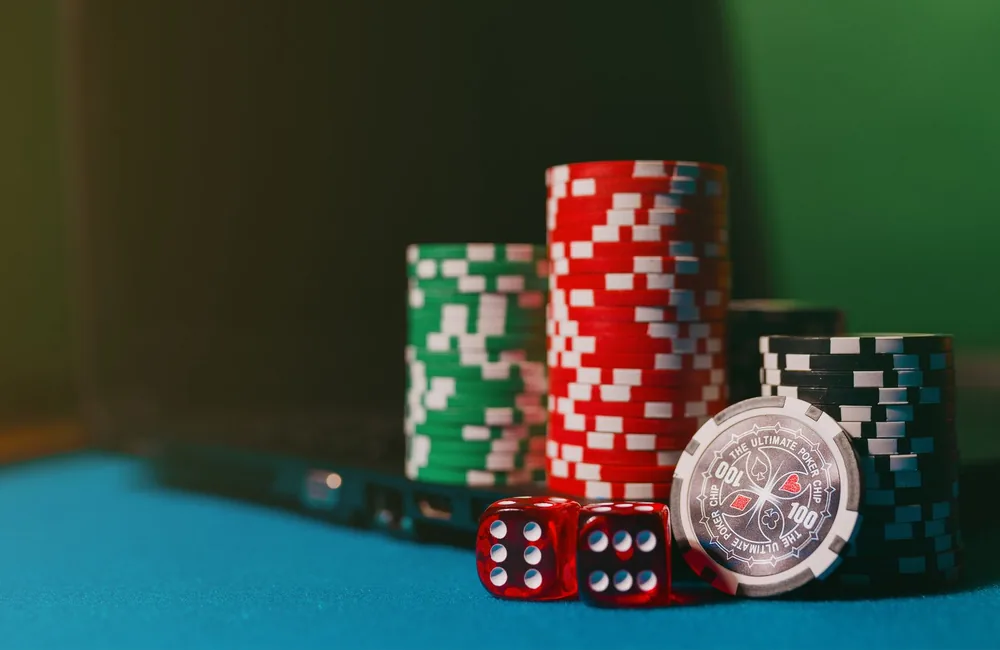Tall stacks of casino chips on felt representing real money gambling stakes