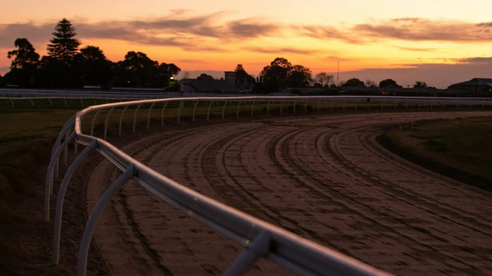 Emptying Australian racecourse at sunset after a long day of racing and sports gambling
